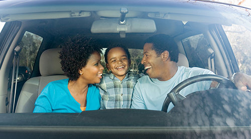 African family laughing inside the car