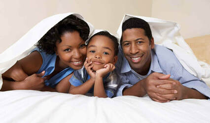 African family lying on the bed